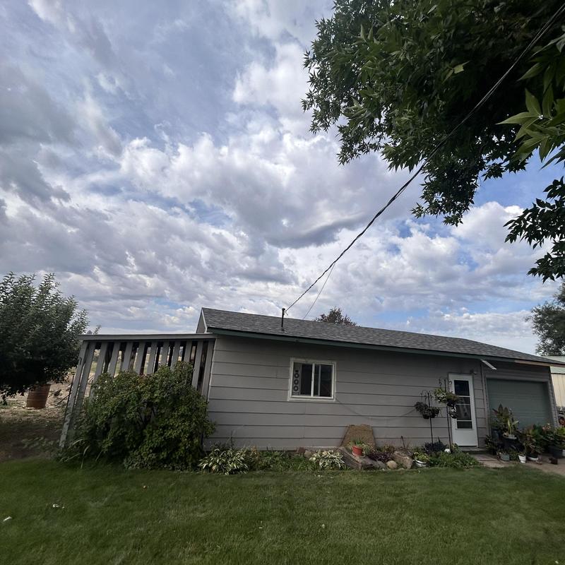 Overhead service line with exposed wiring on house