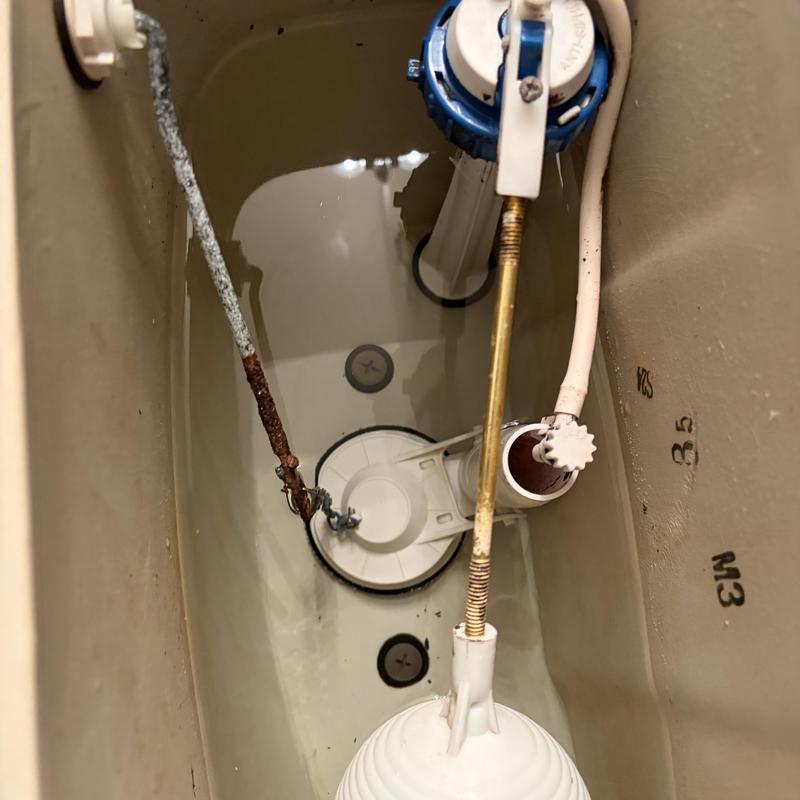 Toilet tank interior with flush valve and fill valve components