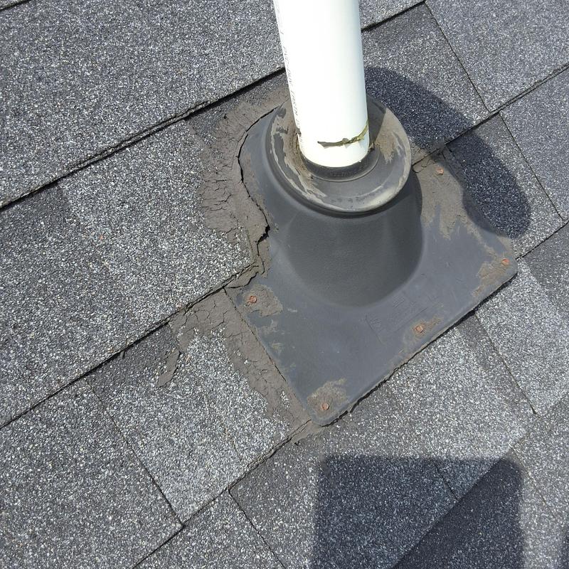Plumbing vent collar on asphalt shingle roof with damage Plumbing vent collar on asphalt shingle roof with damage