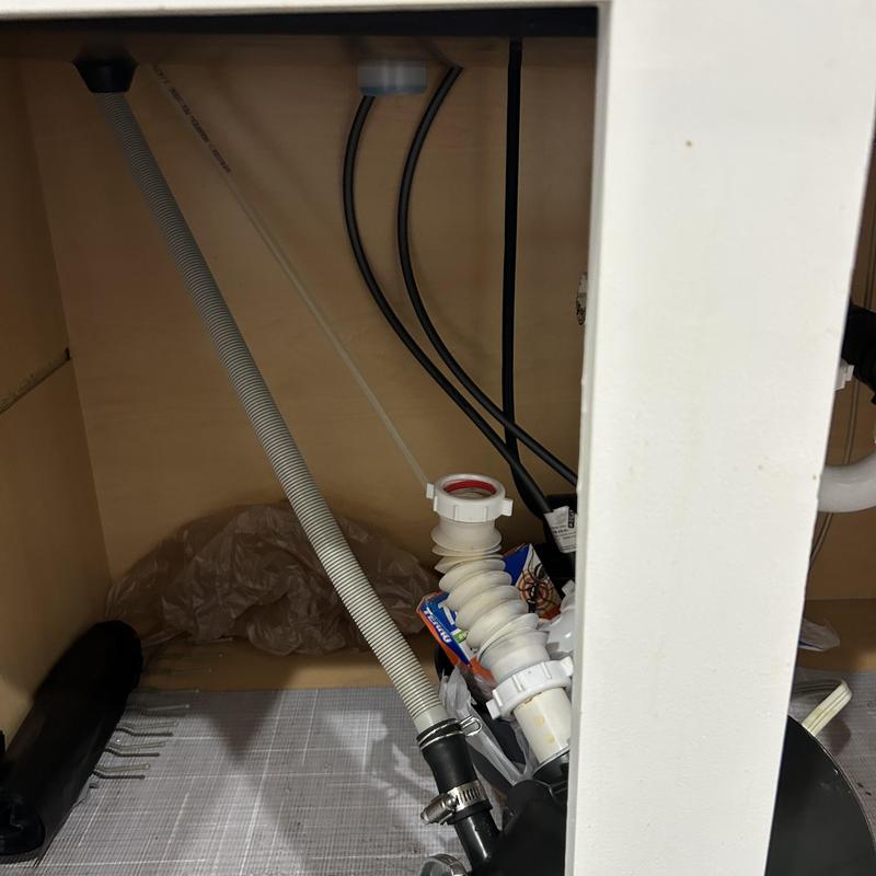 Sink disposal drain pipe disconnected under cabinet