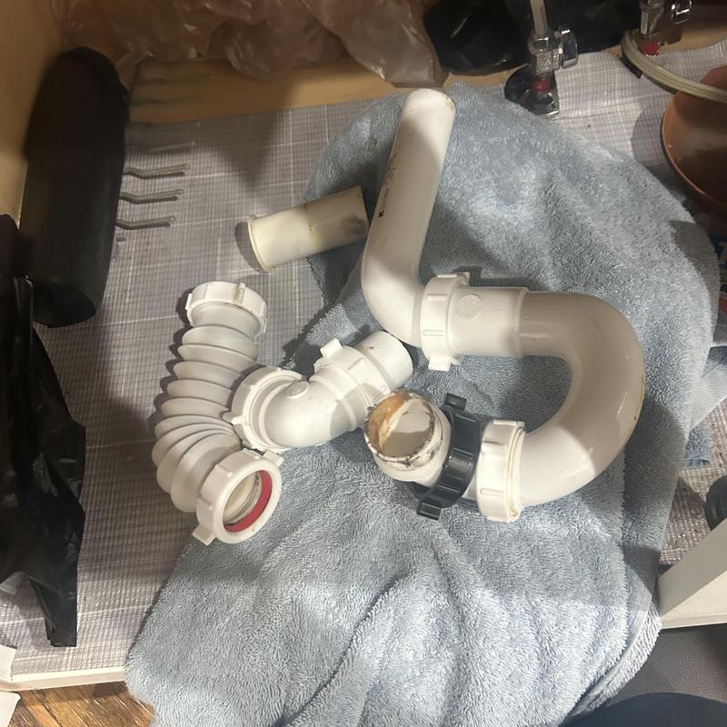 Sink drain pipes removed and laid out on towel