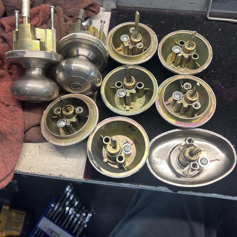 Door knob lock components disassembled for rekeying Door knob lock components disassembled for rekeying
