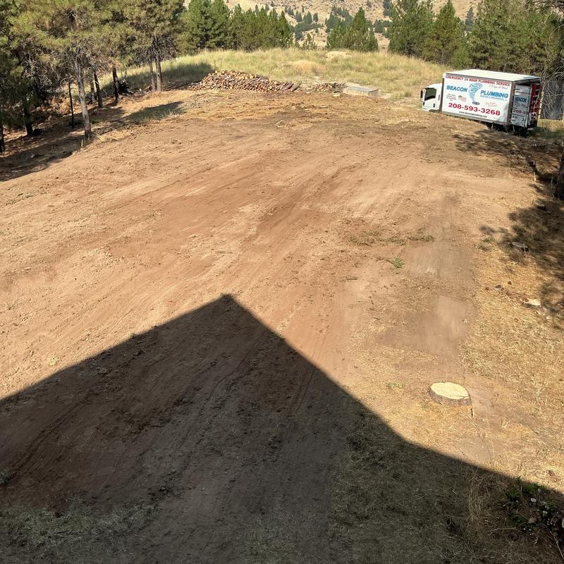 Drain field installation site with plumbing truck