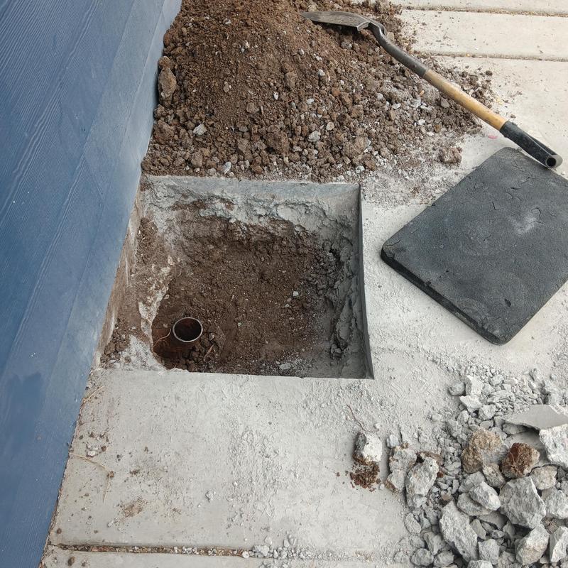 Concrete slab with exposed plumbing pipe and soil excavation Concrete slab with exposed plumbing pipe and soil excavation