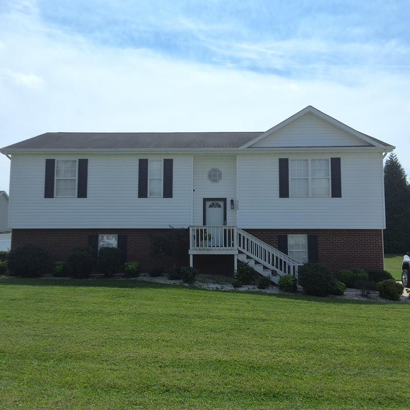 Asphalt shingle roof with storm damage on residential home