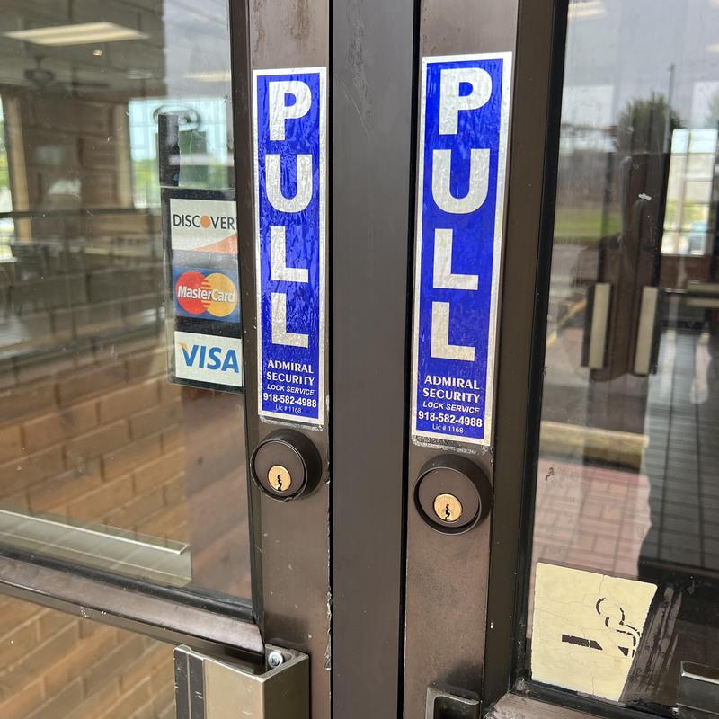 Mortise locks on double glass doors with pull signs Mortise locks on double glass doors with pull signs