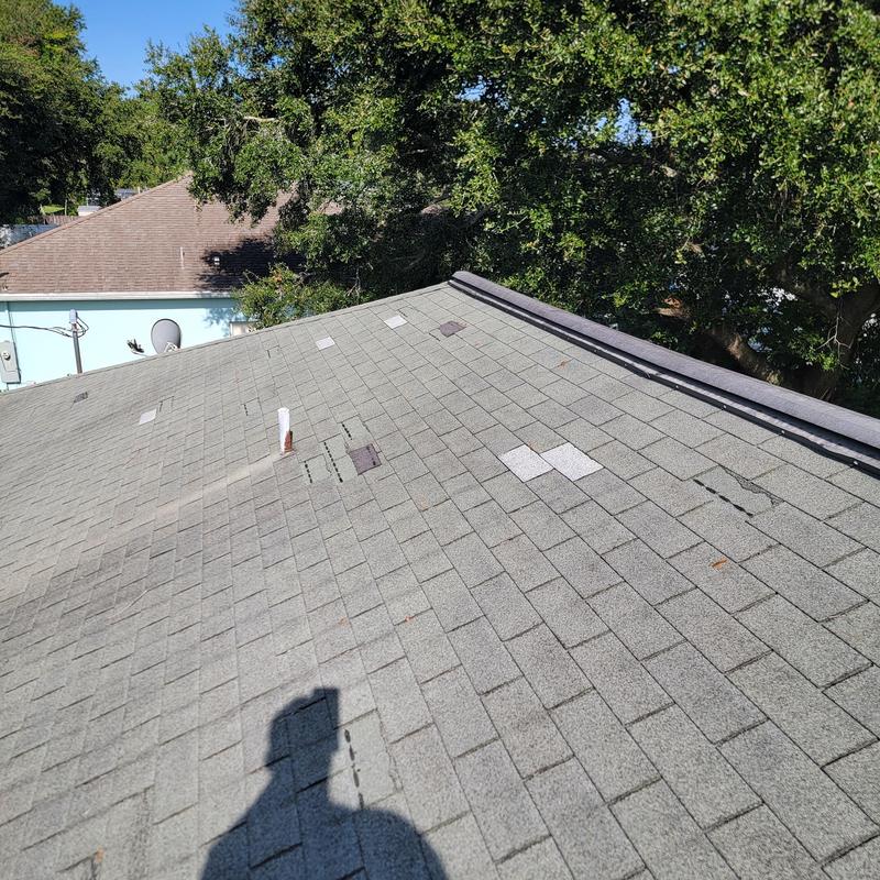 Asphalt shingle roof with damaged and missing shingles Asphalt shingle roof with damaged and missing shingles