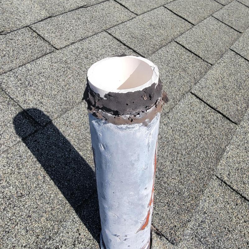 Roof plumbing vent pipe with deteriorated sealant on shingles Roof plumbing vent pipe with deteriorated sealant on shingles