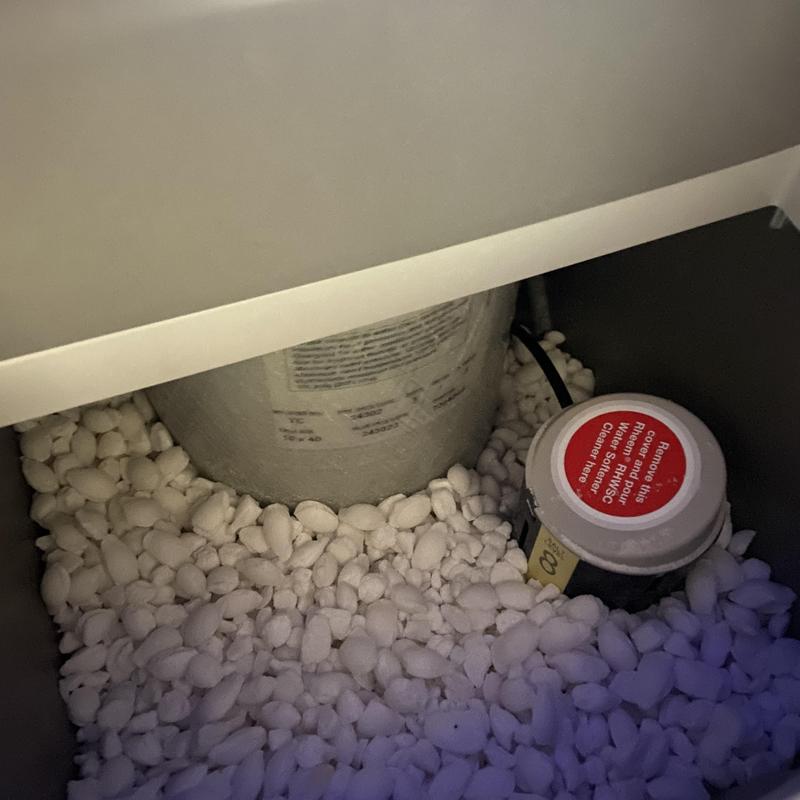 Water heater drain valve surrounded by pea gravel