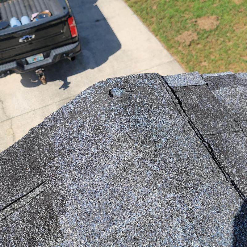 Owens Corning shingle roof edge with damaged nail head Owens Corning shingle roof edge with damaged nail head