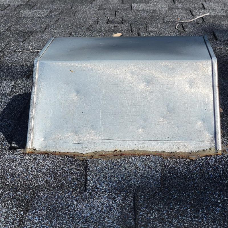 Roof vent with rust and dented metal on shingles Roof vent with rust and dented metal on shingles