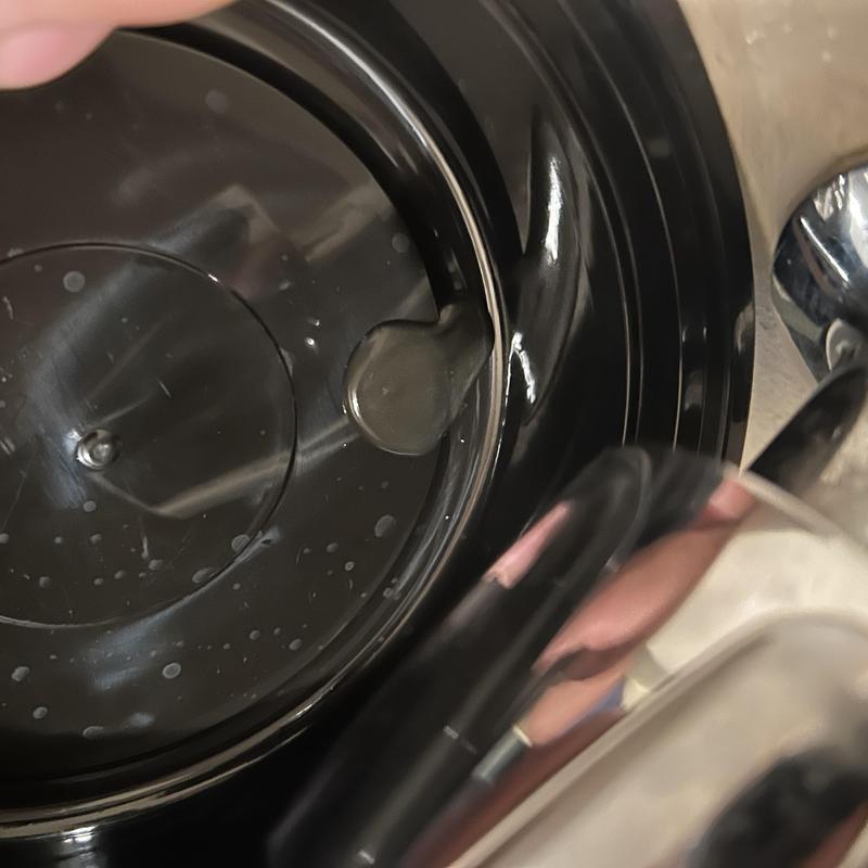 Laundry valve leak showing valve handle and water droplets