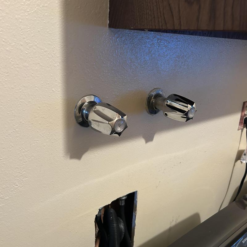 Laundry water supply valves with exposed plumbing hole