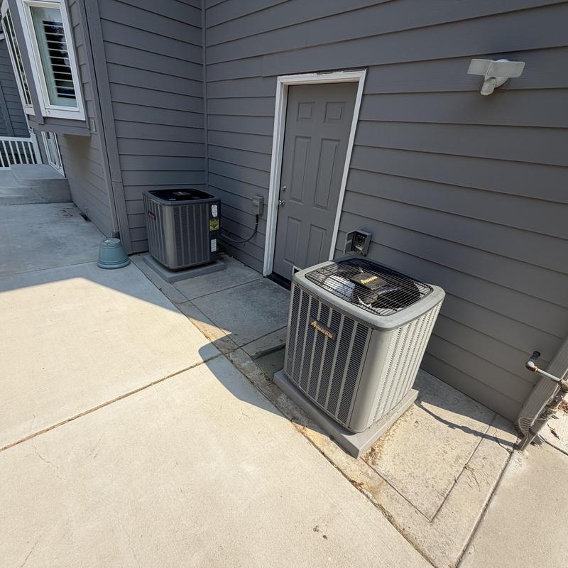 Outdoor AC units side by side on concrete pad