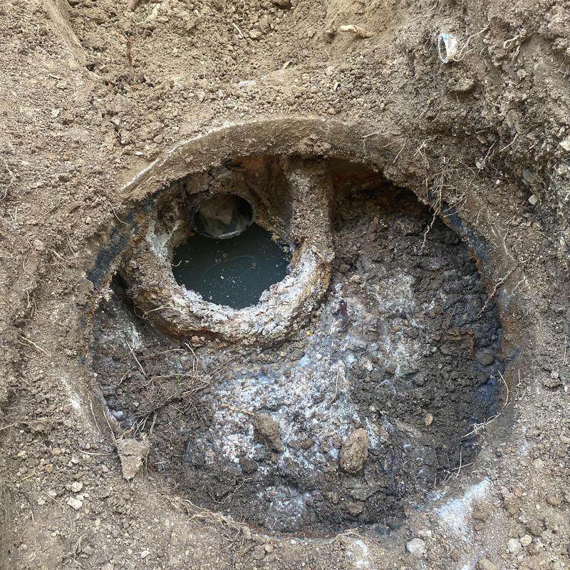 Septic tank opening with sewage and surrounding soil