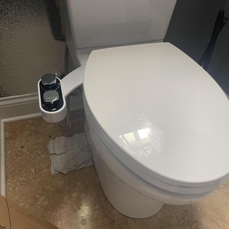 Bidet seat control panel on toilet installed