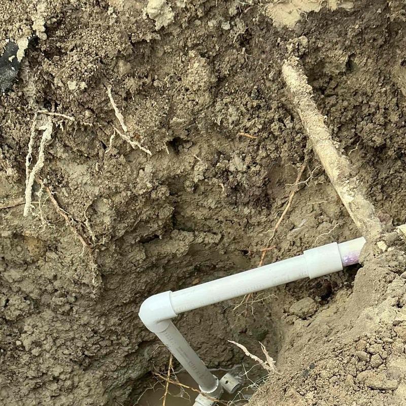 1-inch PVC pipe installation with elbow fitting underground
