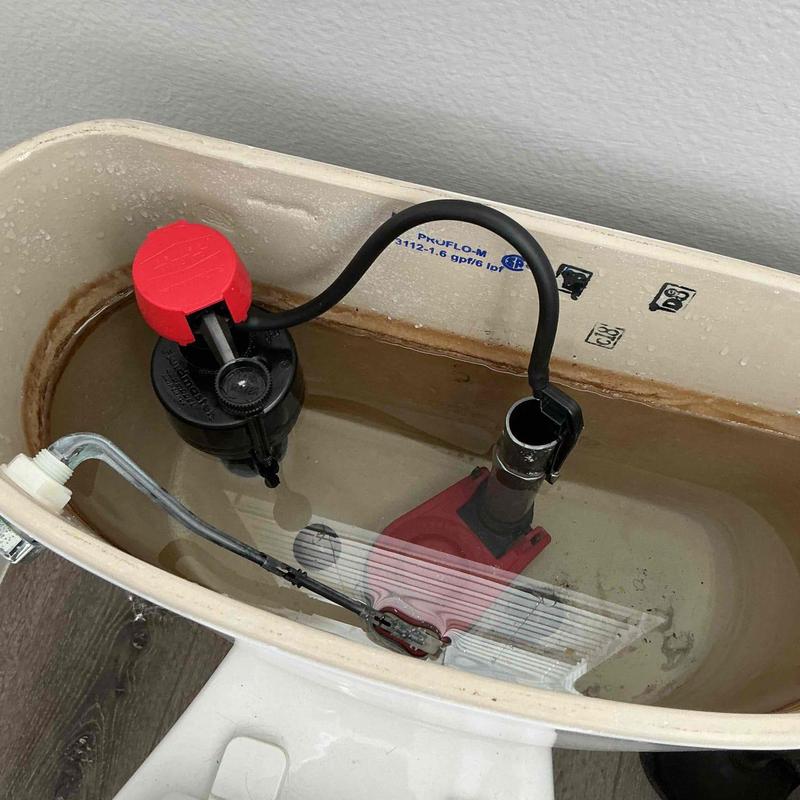 Toilet fill valve and flapper installed inside tank