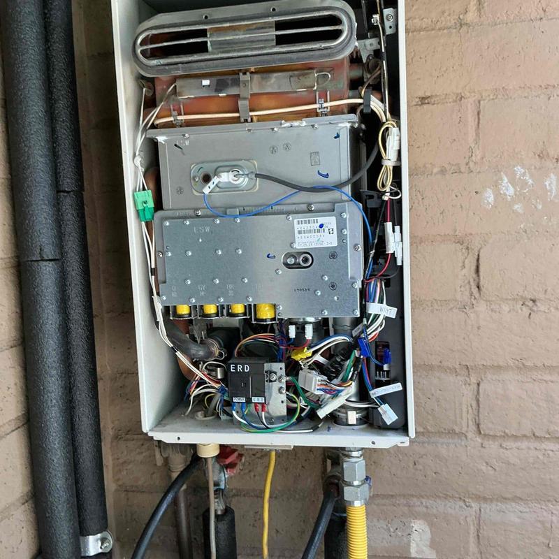 Tankless water heater interior with wiring and valves