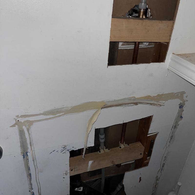 Copper water supply lines in wall cavity with drywall removed