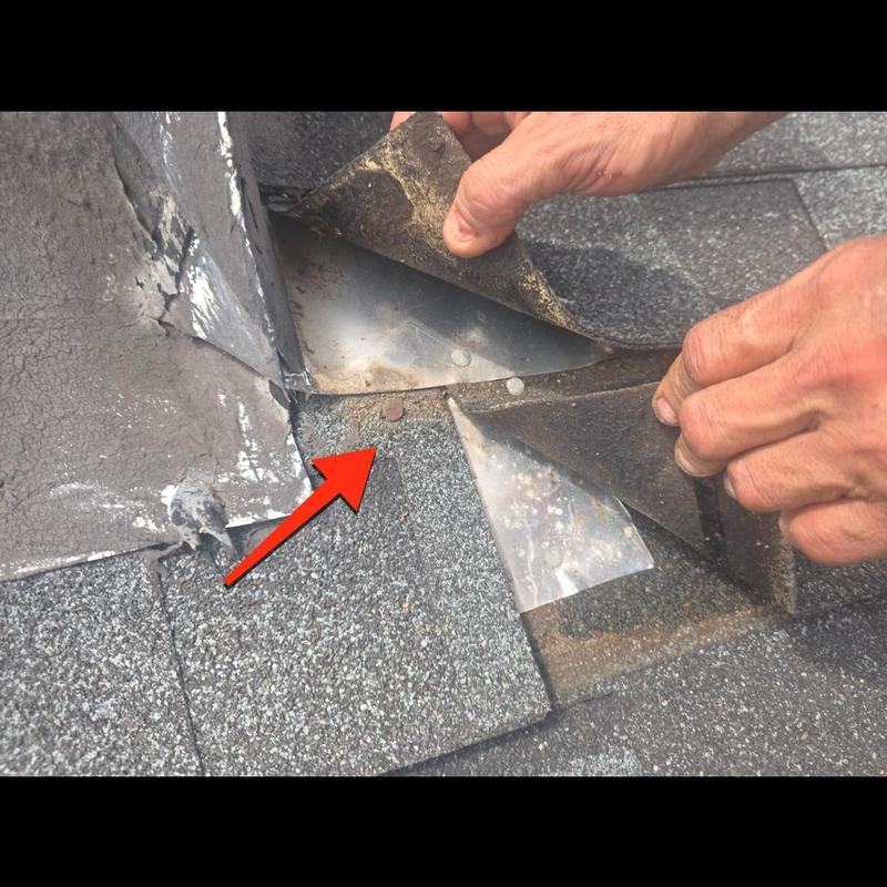 Chimney flashing lifted to inspect roof leak Chimney flashing lifted to inspect roof leak