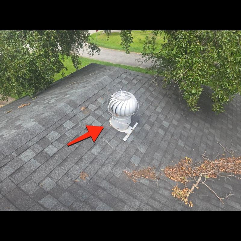 Turbine whirlybird vent on shingle roof with red arrow Turbine whirlybird vent on shingle roof with red arrow