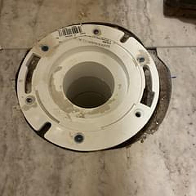Closet flange installed on tiled bathroom floor