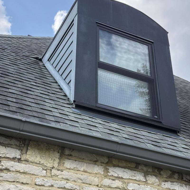 Window with metal flashing trim on roof dormer Window with metal flashing trim on roof dormer