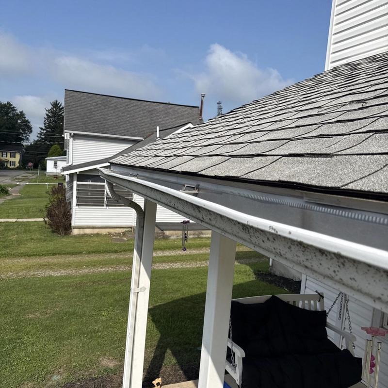 Gutter system along porch roof with shingles Gutter system along porch roof with shingles