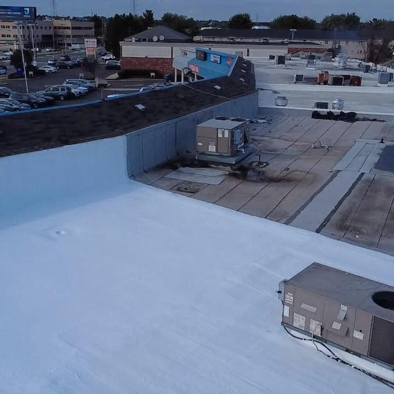 Silicone roof coating system on commercial building roof