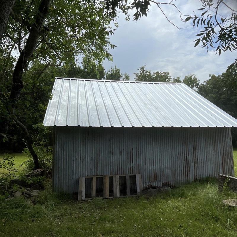 Metal roof panels on rustic corrugated metal shed