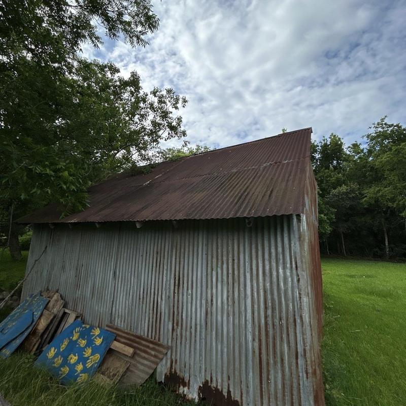 Corrugated metal roofing on rusty shed exterior