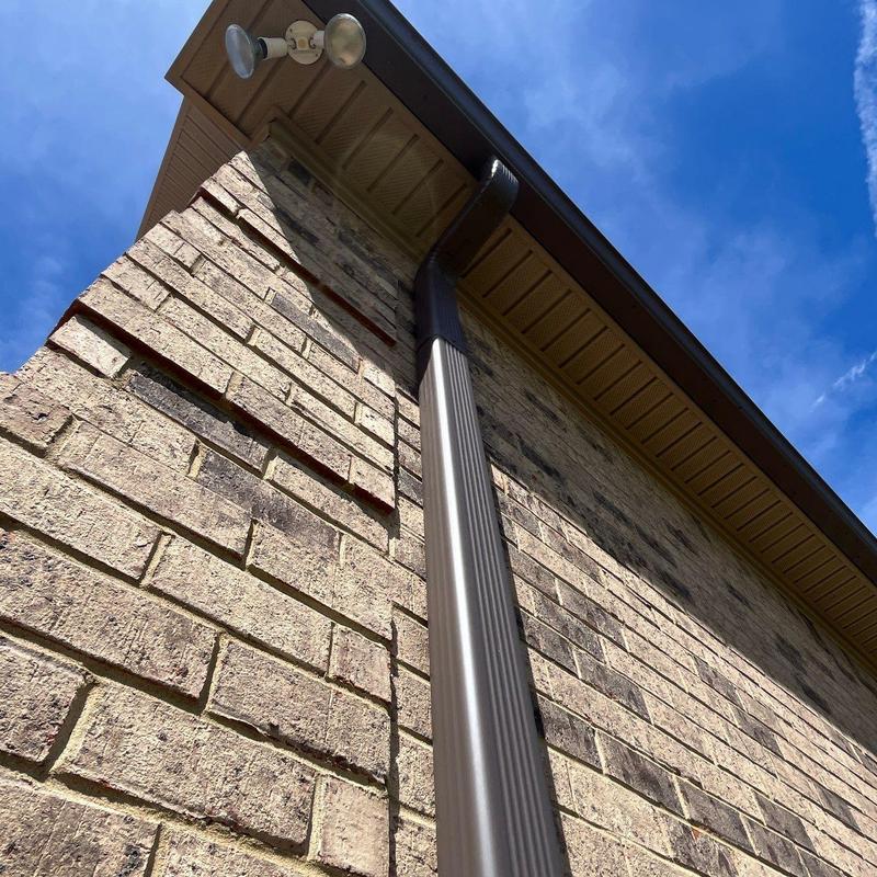 Downspout and gutter system on brick wall exterior