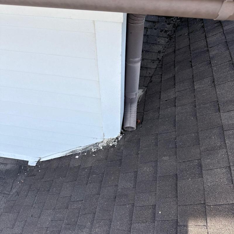 Asphalt shingle roof with gutter downspout and flashing