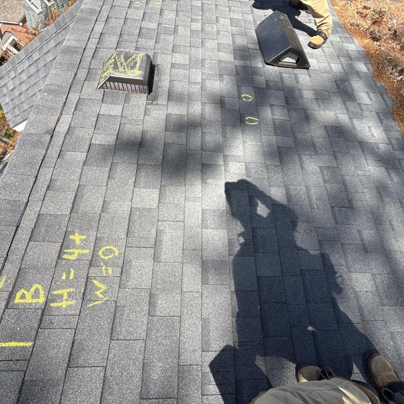 Asphalt shingle roof with hail damage markings