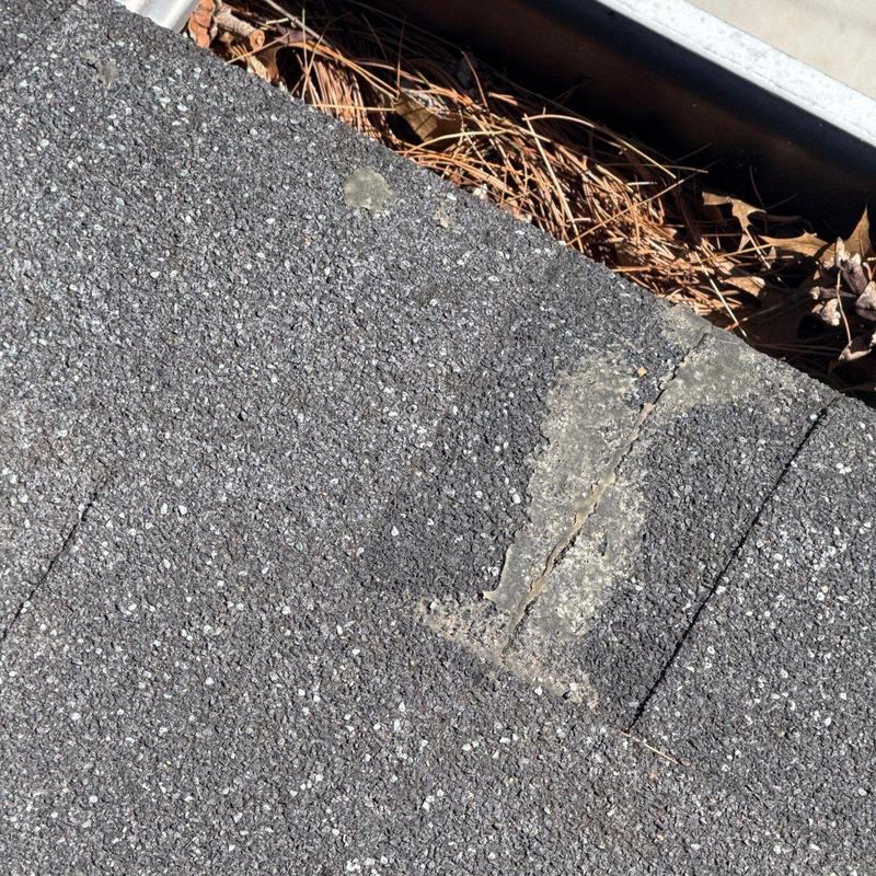 Asphalt shingle roof with hail damage and cracks