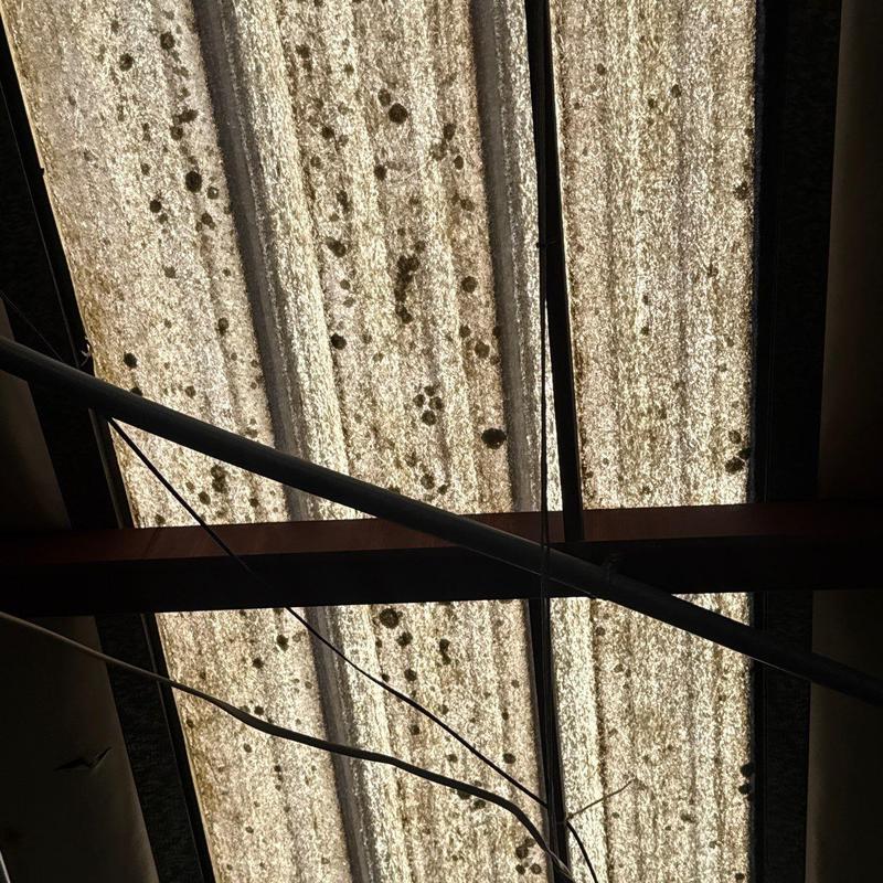 Corrugated roof panels with hail damage and rust marks