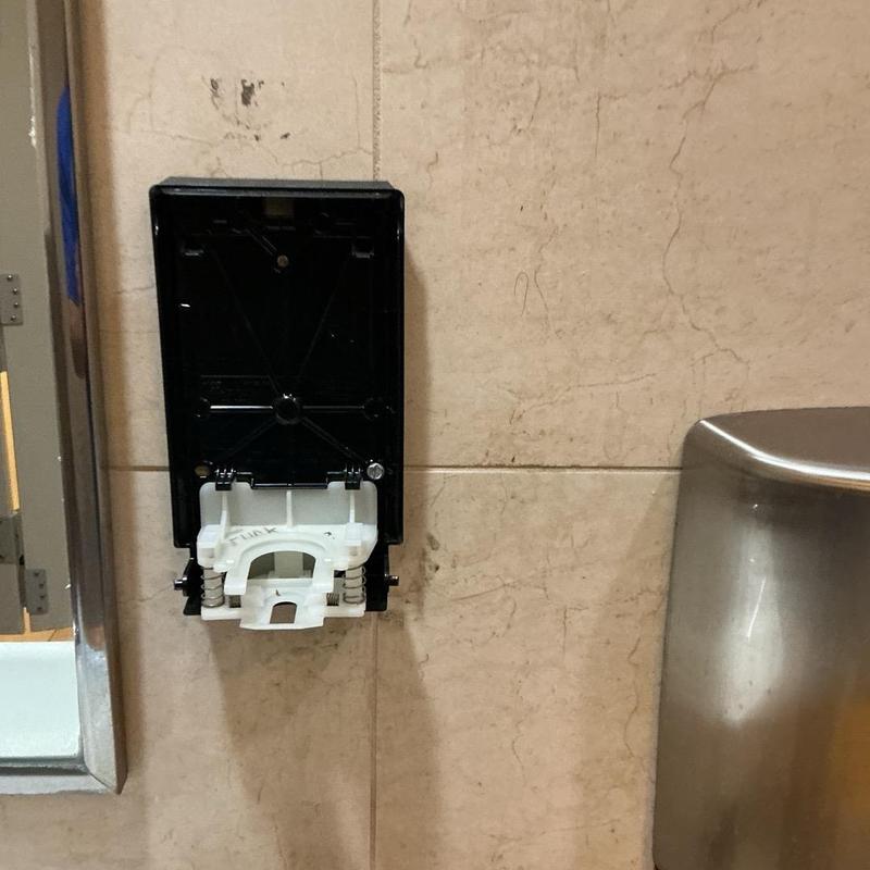 Soap dispenser frame in men's handicap stall Soap dispenser frame in men's handicap stall