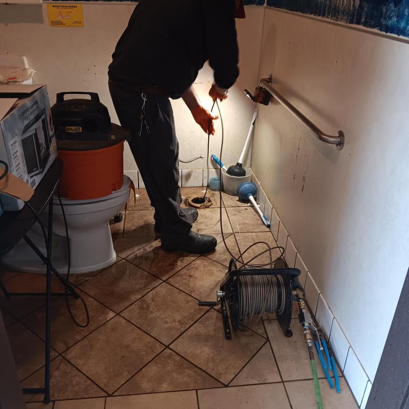 Bathroom drain line with snake cable for clog removal Bathroom drain line with snake cable for clog removal