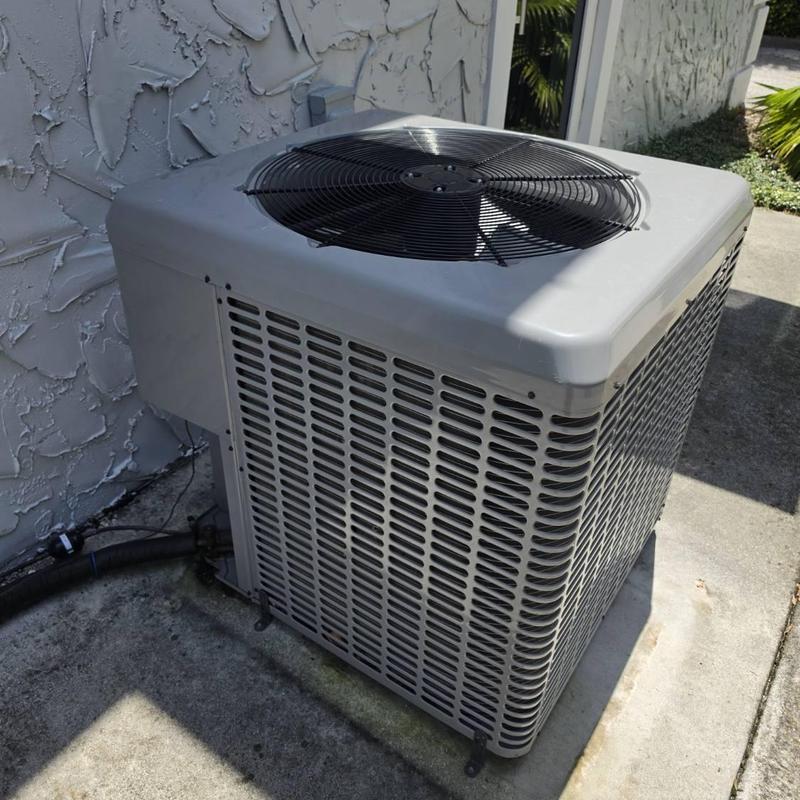 Outdoor AC condenser unit on concrete slab outdoors Outdoor AC condenser unit on concrete slab outdoors