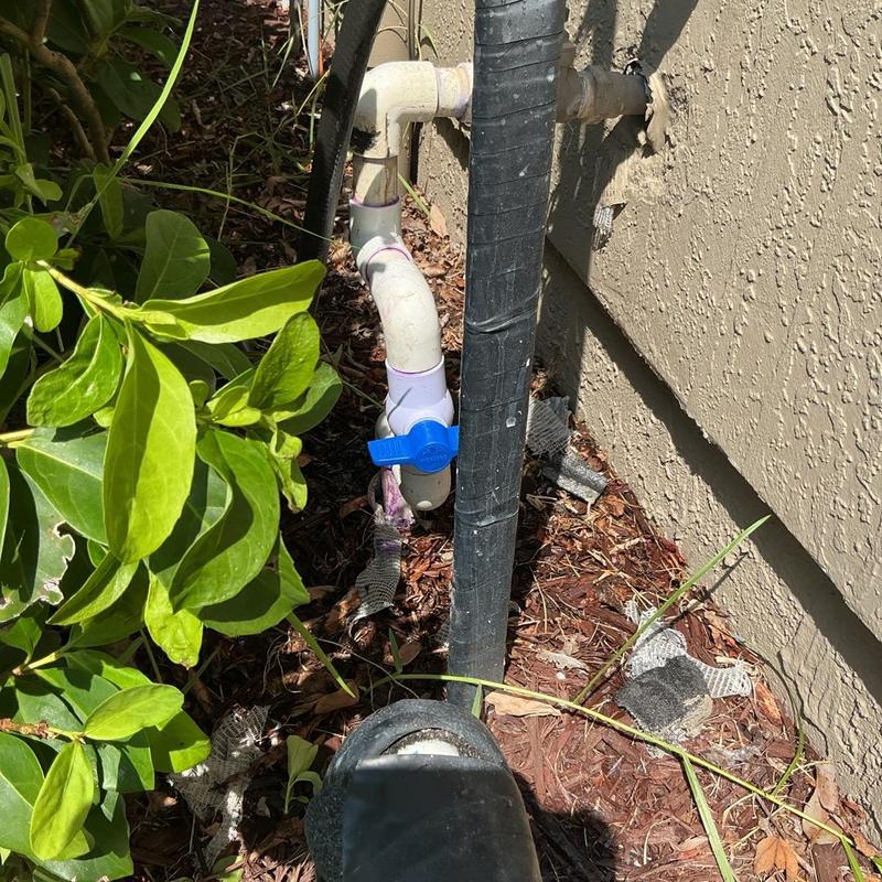 Isolation valve on PVC pipe with blue handle outside home Isolation valve on PVC pipe with blue handle outside home