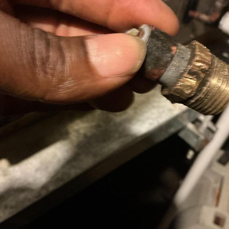 Gas pipe fitting held during leak repair under house Gas pipe fitting held during leak repair under house