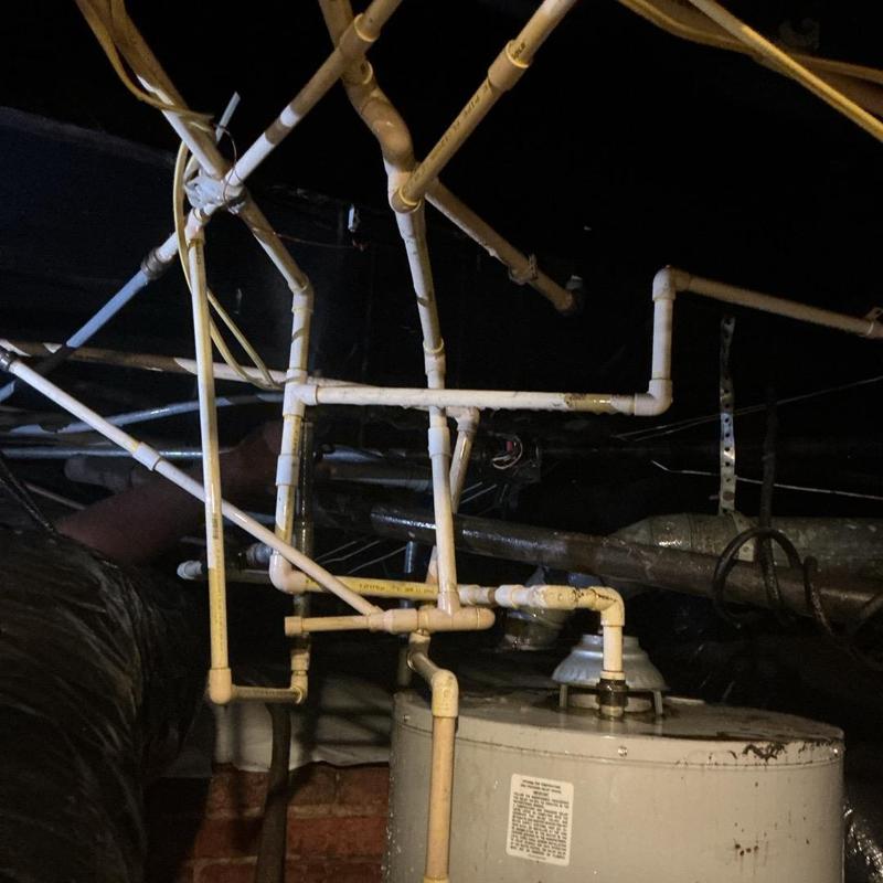 Water heater piping and leak repair under house in crawlspace Water heater piping and leak repair under house in crawlspace
