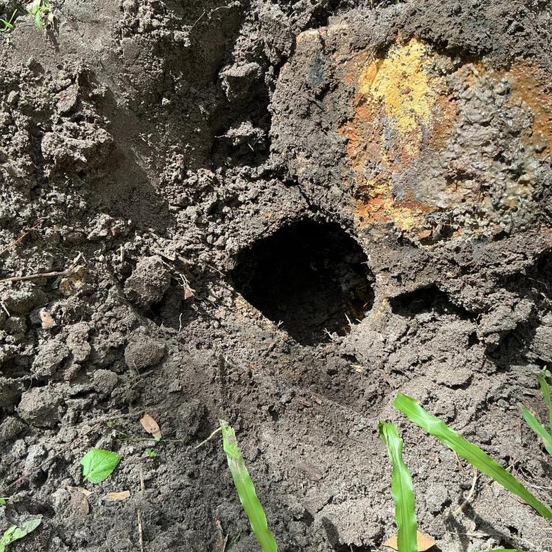 Sewer line excavation showing hole and rusted pipe Sewer line excavation showing hole and rusted pipe