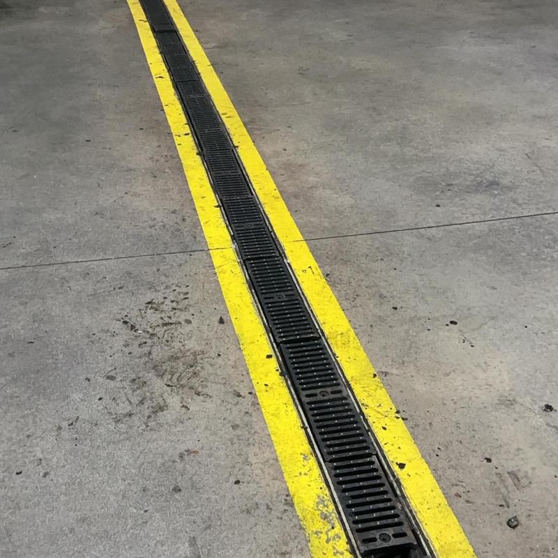 Trench drain grates secured with yellow safety lines Trench drain grates secured with yellow safety lines