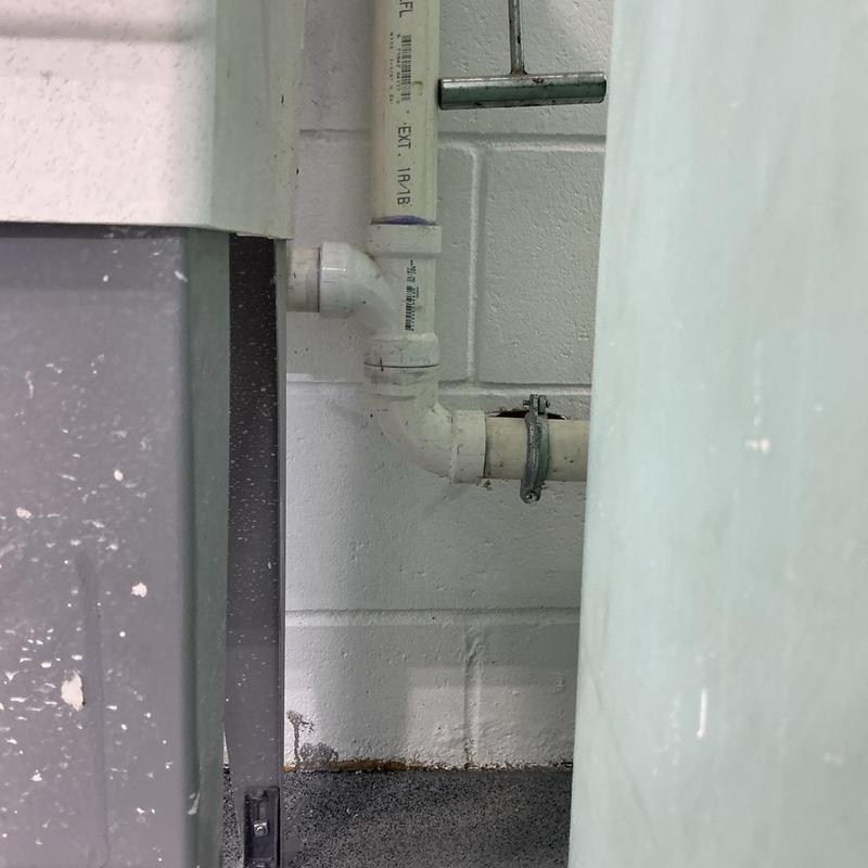 Eye wash station PVC drain pipe installation in wall corner Eye wash station PVC drain pipe installation in wall corner