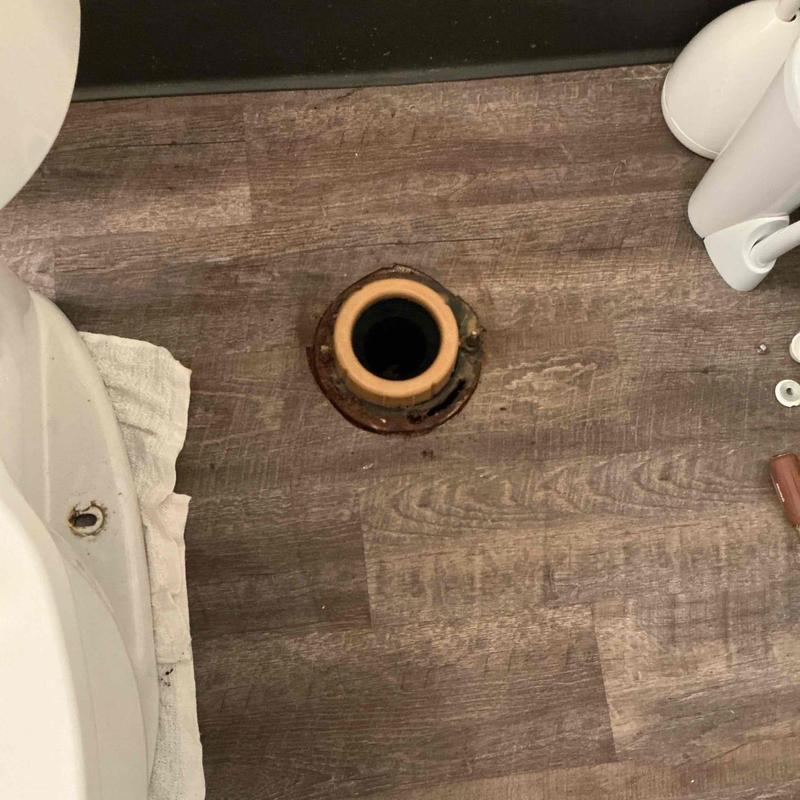 Toilet flange on wood floor with removed wax seal