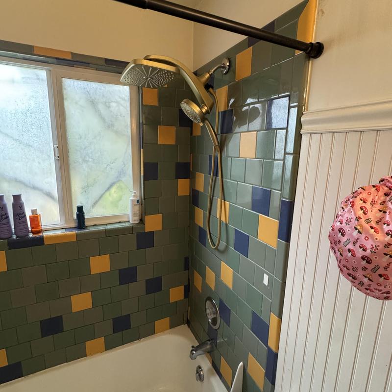 Gold finish shower head and handle installation in shower