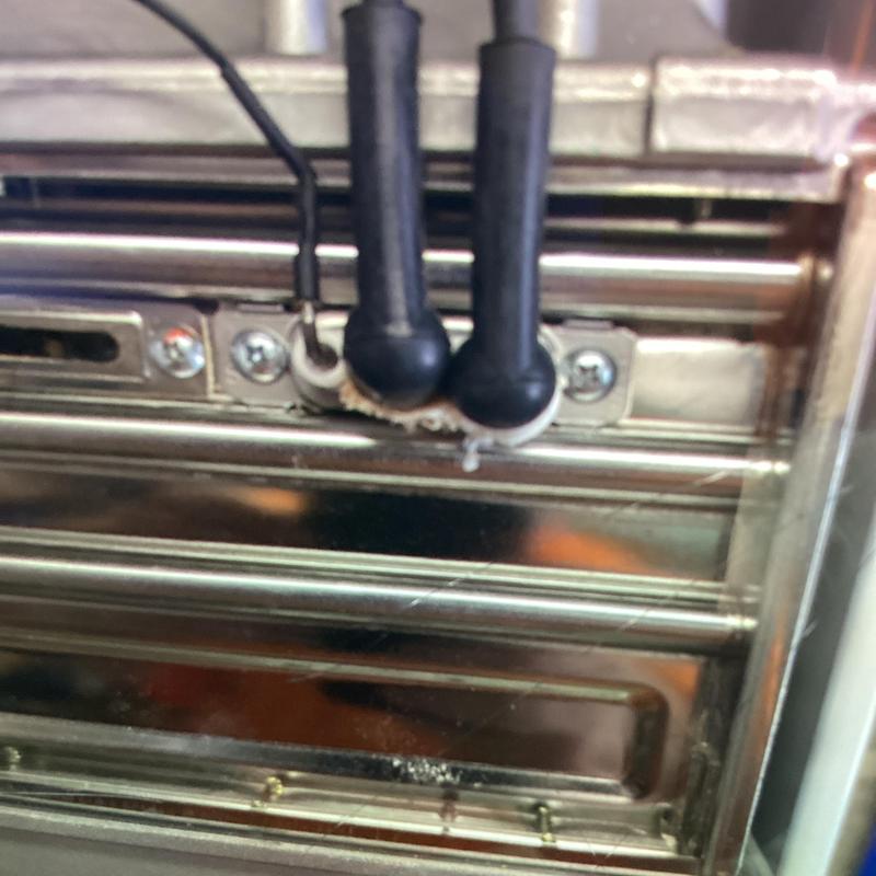 Water heater ignition rods and wiring connections close-up