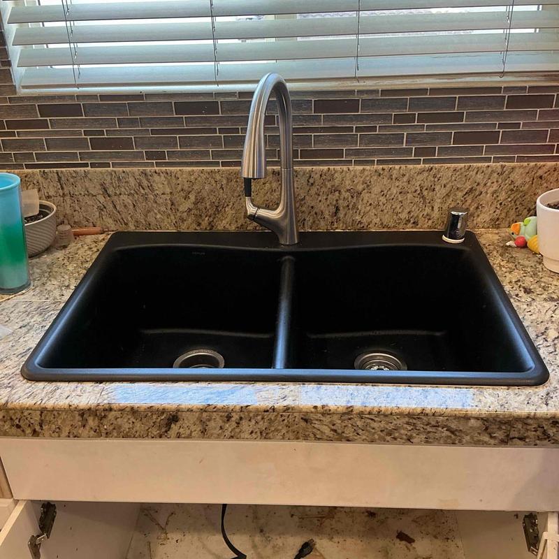 Kitchen sink and faucet installation on granite counter